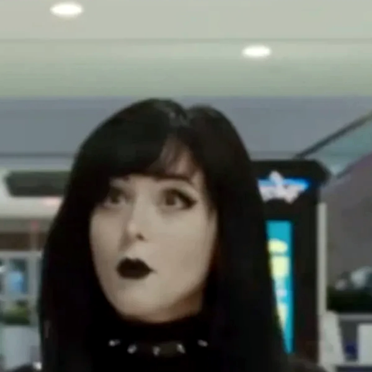 Pinkchyu in black, studded choker and dark lip, mall light behind her
