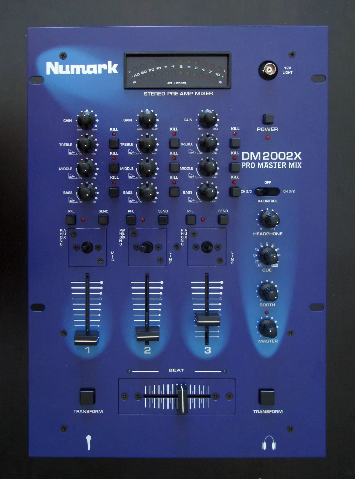A DJ mixer on a table, faders and knobs, no one at it.