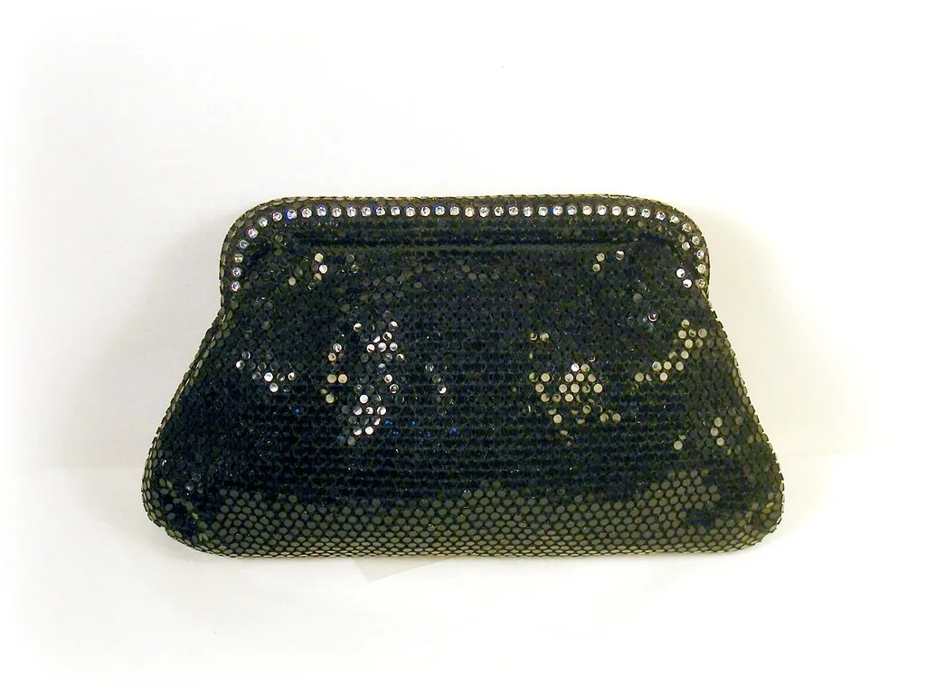 Tiny studded black clutch with silver chain.