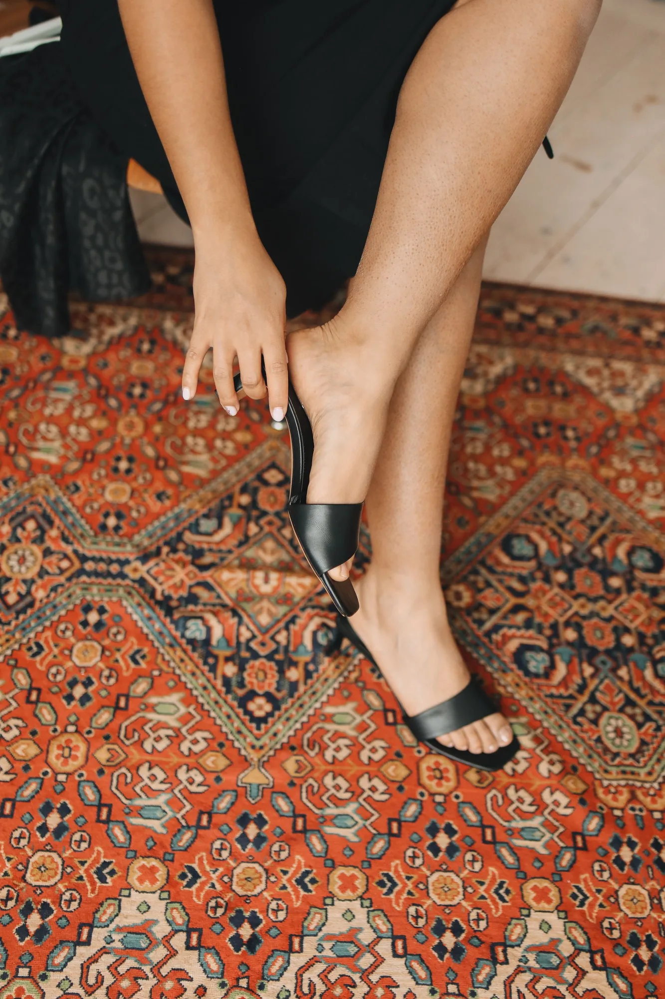 Black 1990s platform pumps on a patterned rug.